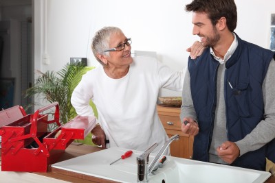 Oakland plumber talks with customer during a sink repair service call